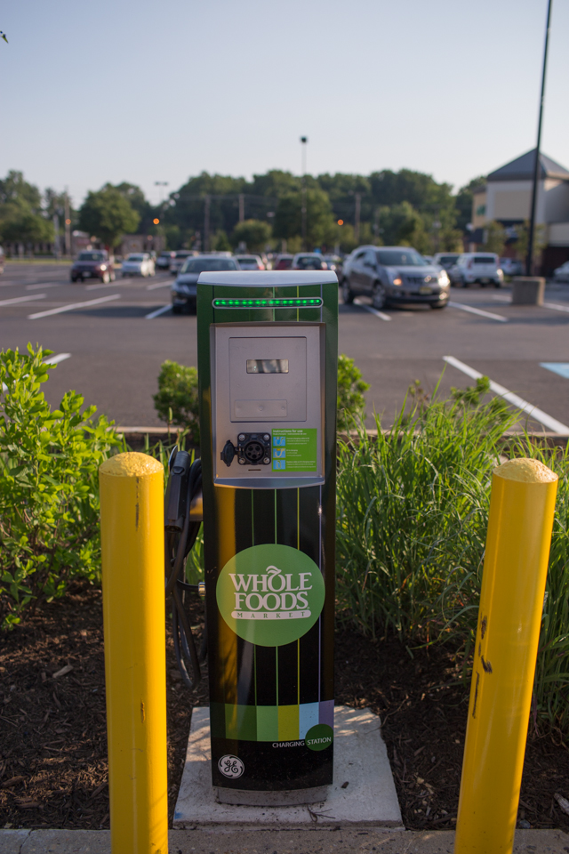 One of a few electric car charging stations in the Cherry Hill Whole Foods parking lot. The station adjoins a rain garden designed to divert runoff from inclement weather. Credit: Tricia Burrough/Lilac Blossom Photography.