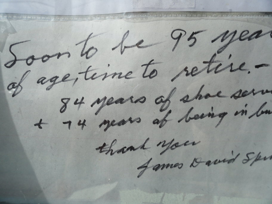 The handwritten farewell note from Spinelli that hangs in the window of Quaker Shoe Repair. Credit: Matt Skoufalos.