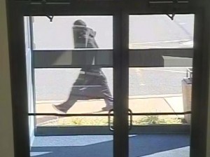 The burqa-clad individual seen in this photo is sought in connection with at least three bank robberies in the area. Credit: Camden County Prosecutor's Office.
